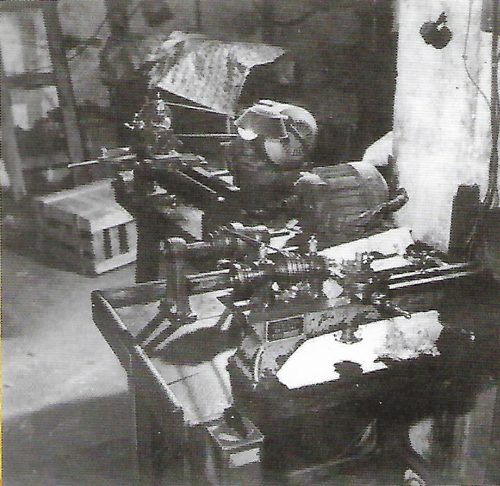Old photograph of an early machine on a bench